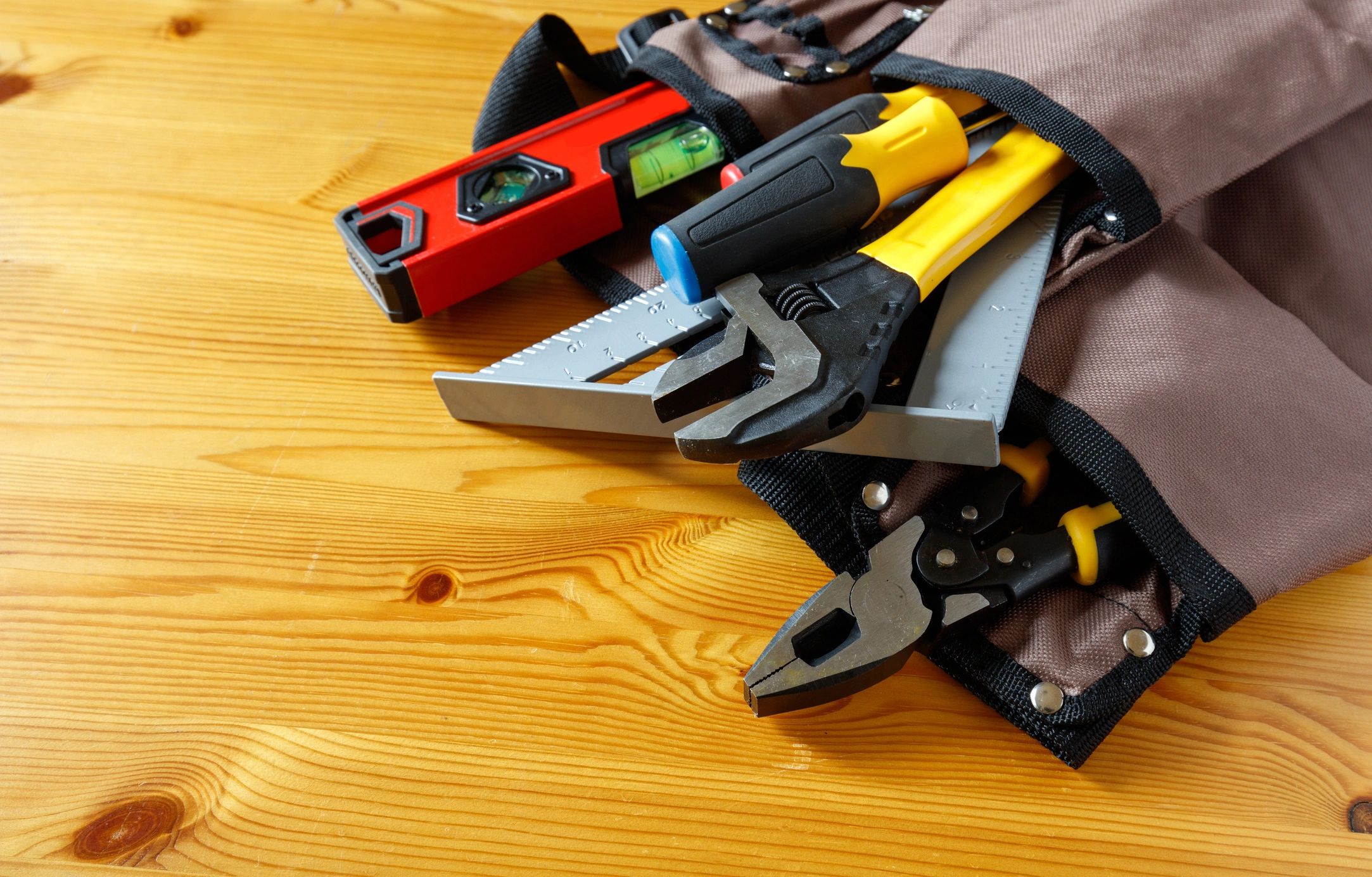 Carpenter tools arranged on wood surface