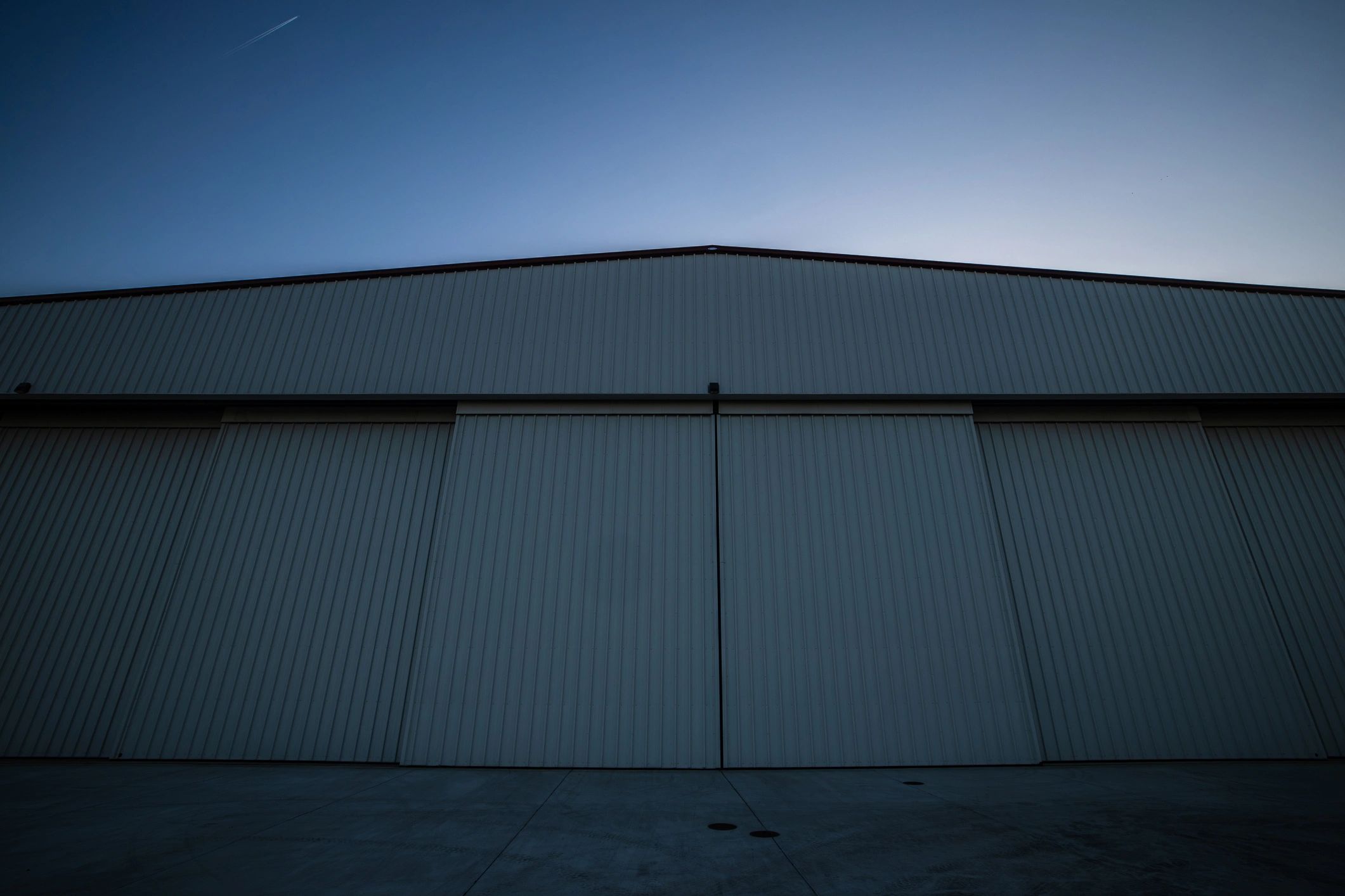 Large steel structure exterior at sunset