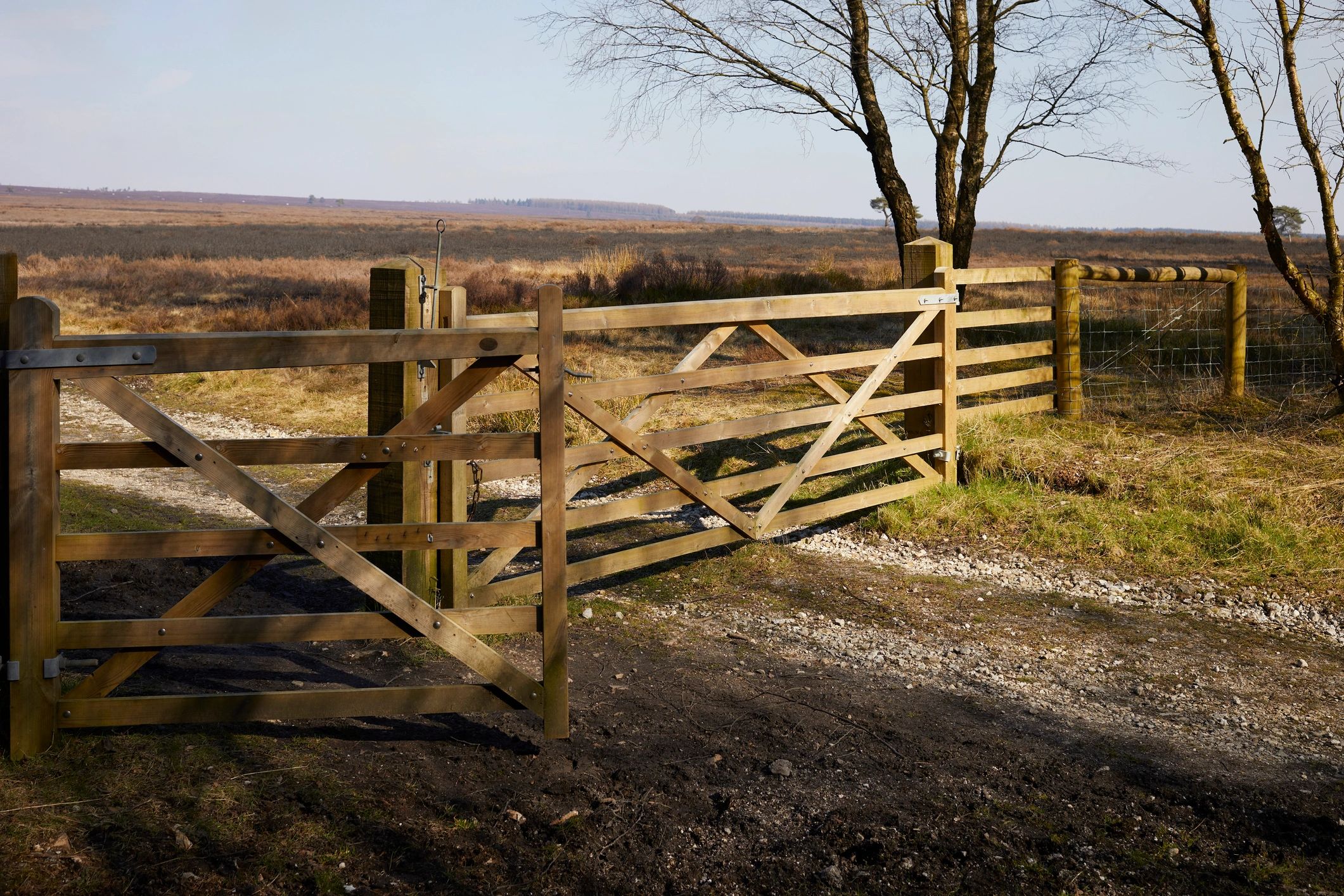 Fence line and gate across open rural land