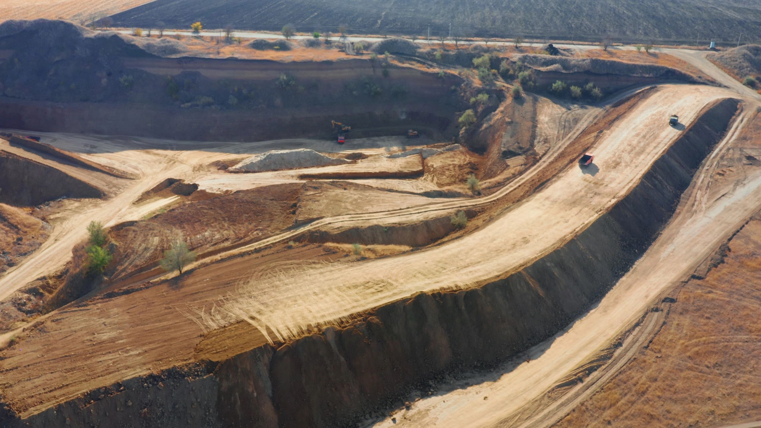 Aerial view of aggregate yard with heavy equipment and material stockpiles