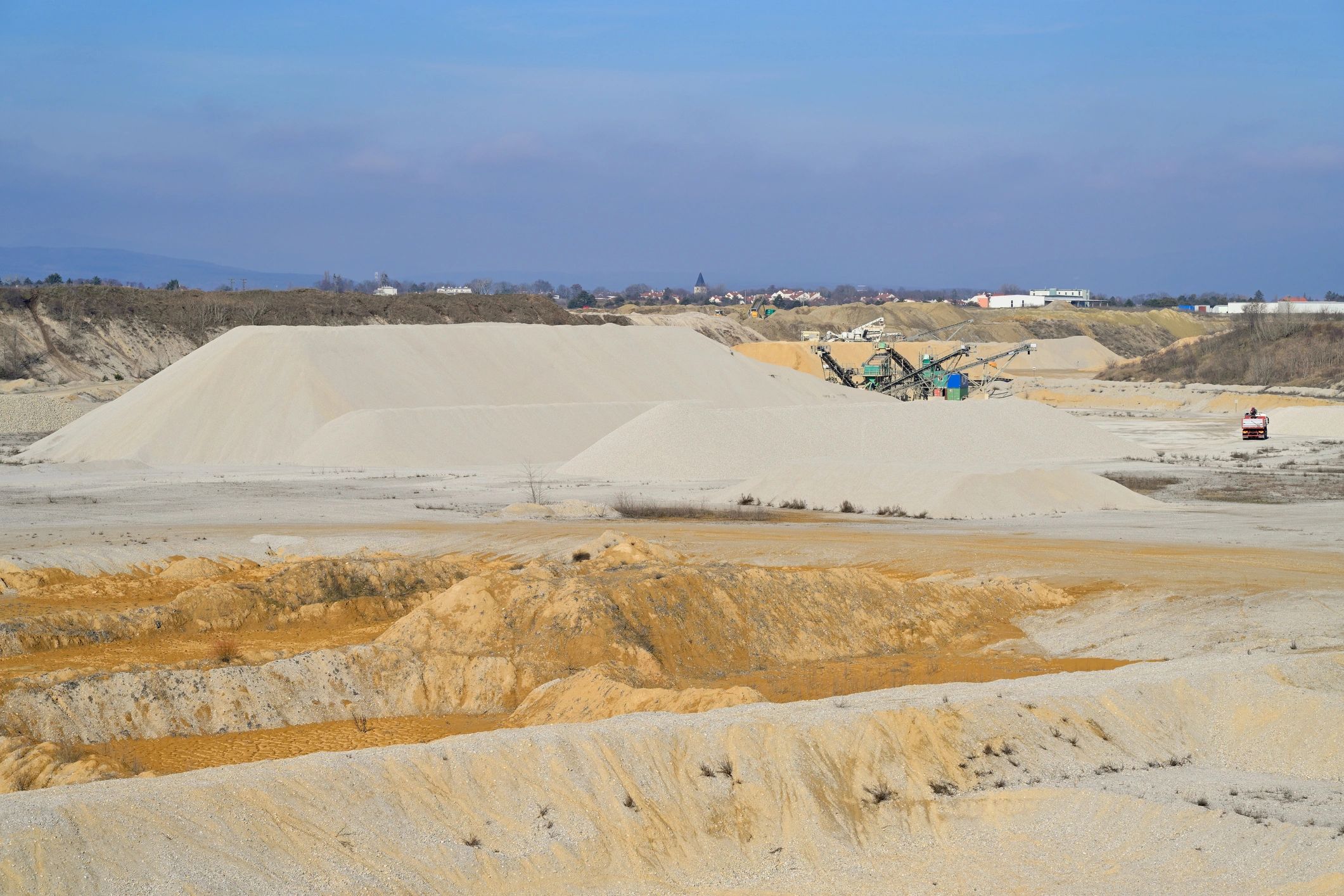 Quarry with sand and gravel piles for aggregate materials