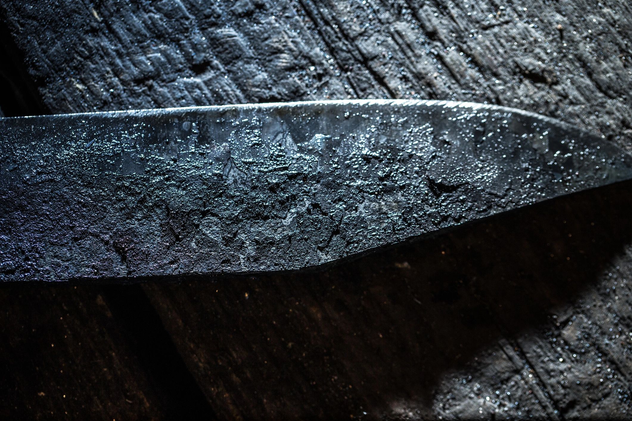 Hand forged knife on wooden surface